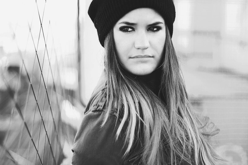woman in beanie looking at camera