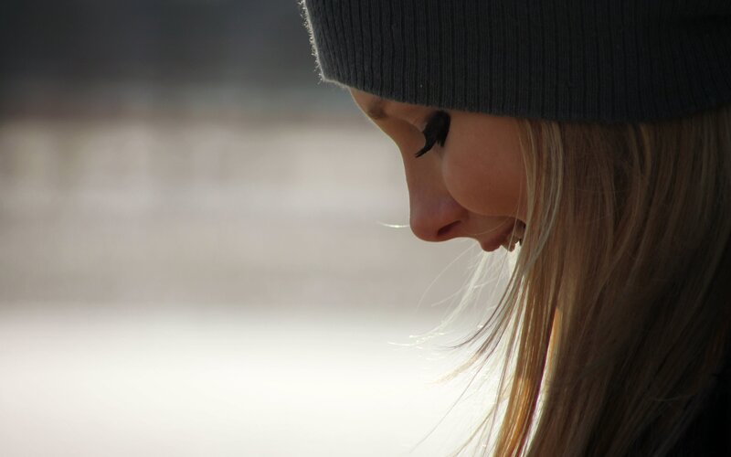 woman in beanie looking down