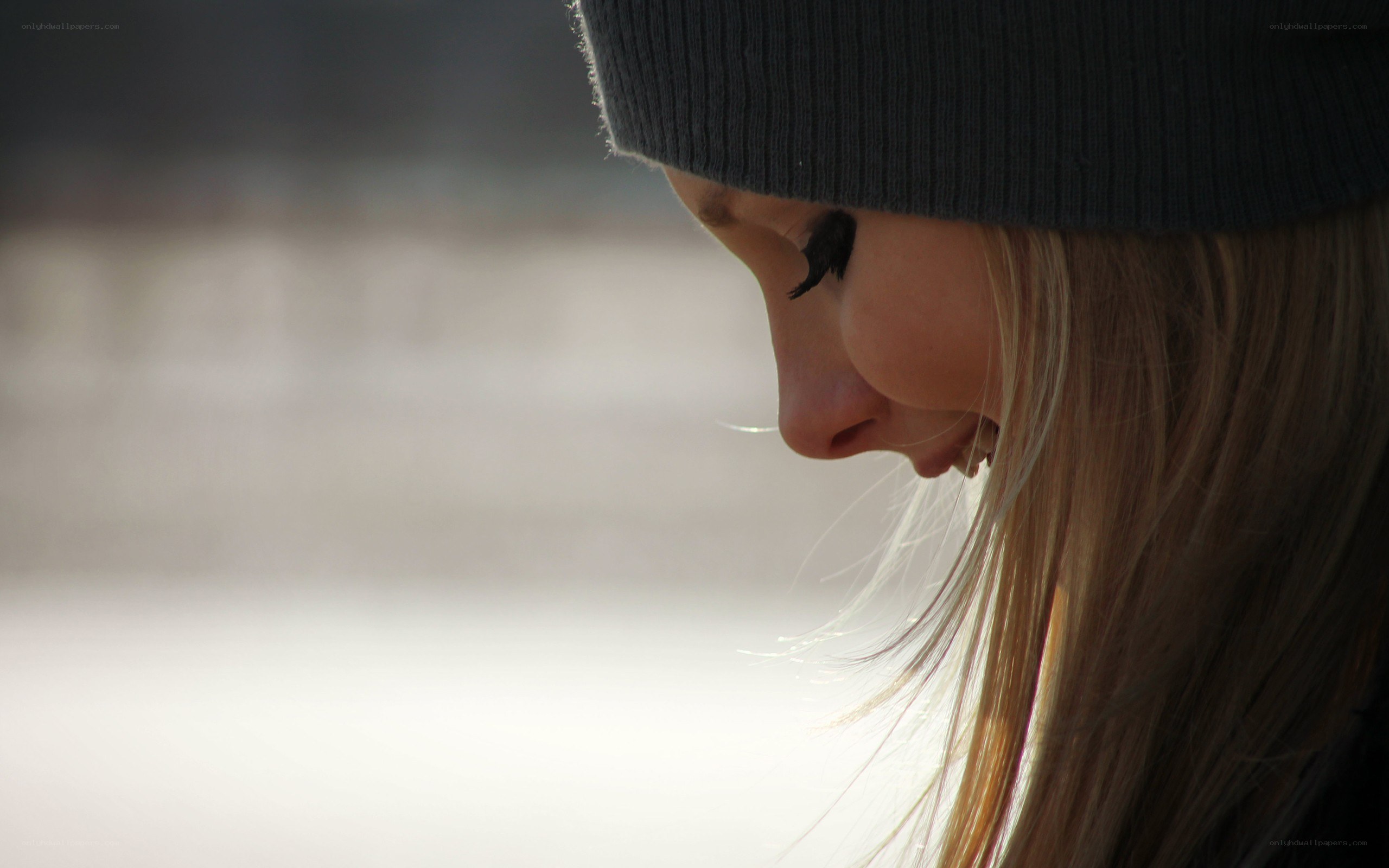 woman in beanie looking down