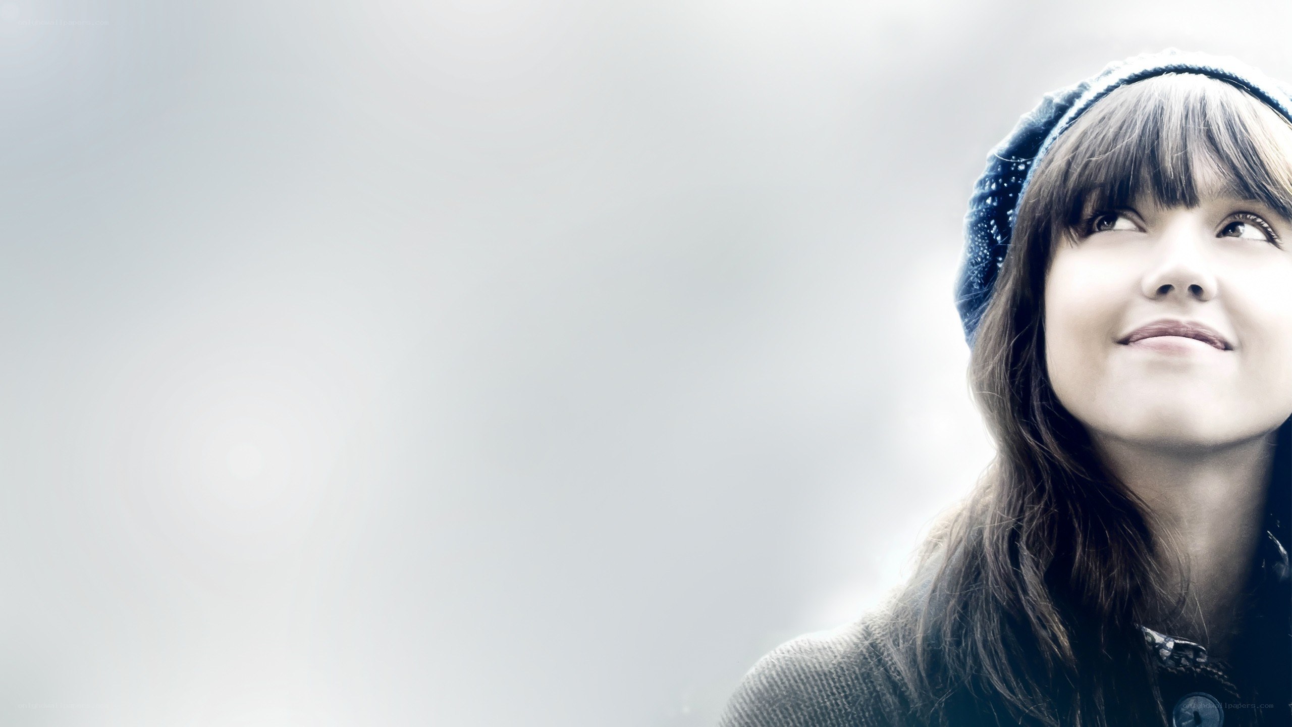 woman in beanie looking up