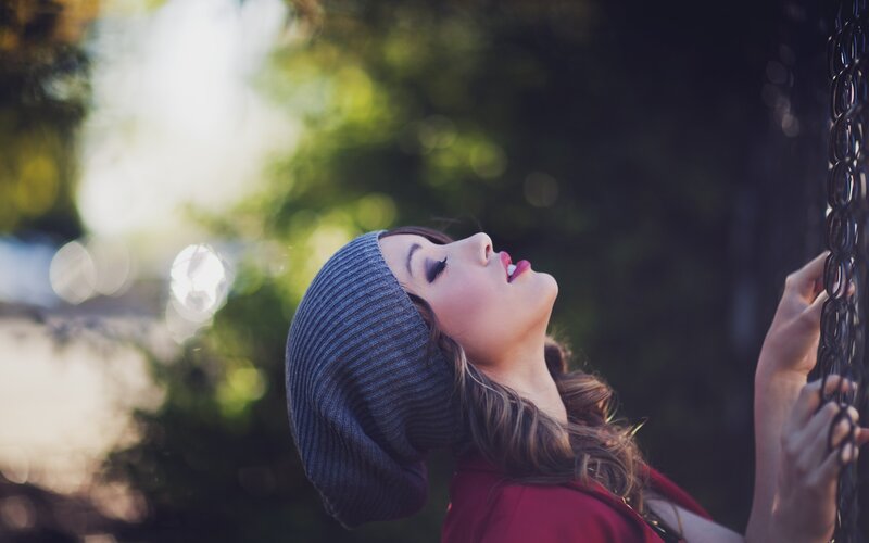woman in beanie on swing