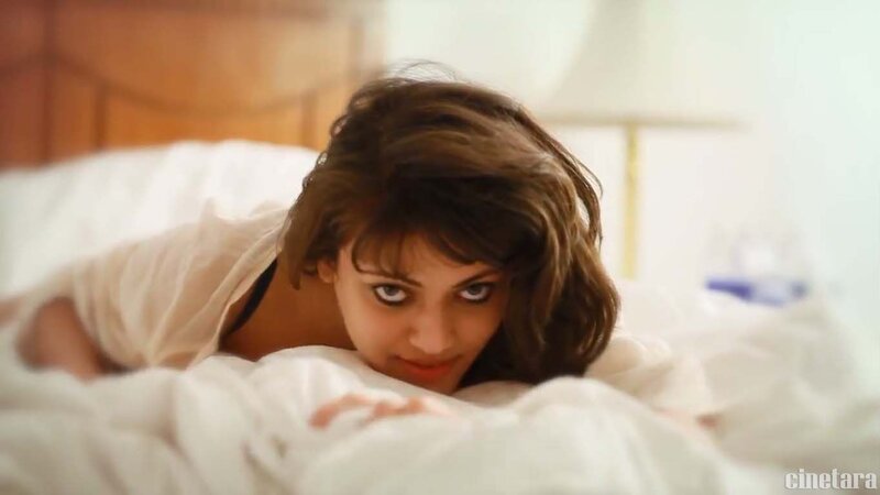 woman in bed looking at camera