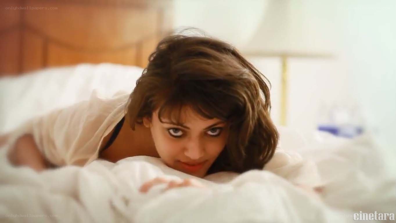 woman in bed looking at camera