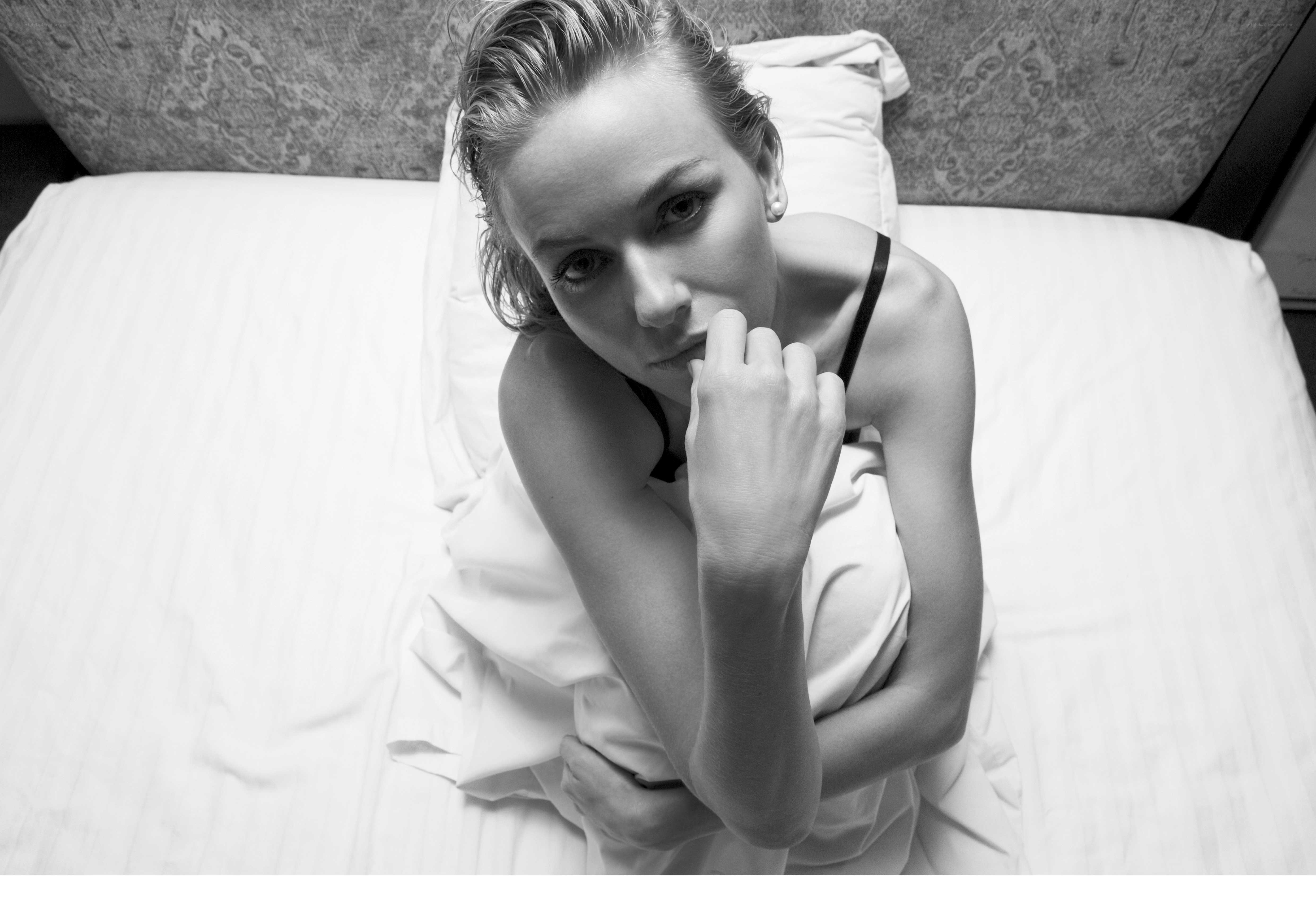 woman in bed looking up