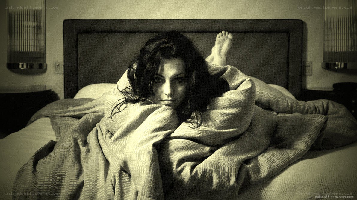 woman in bed under blanket
