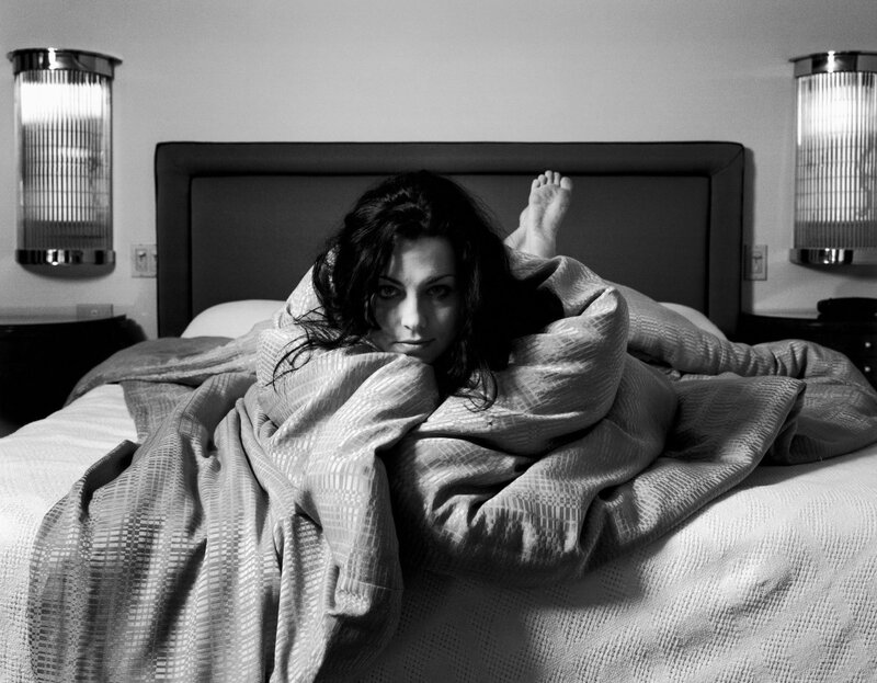 woman in bed under blanket