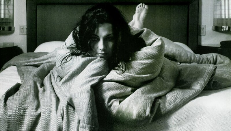 woman in bed under blanket
