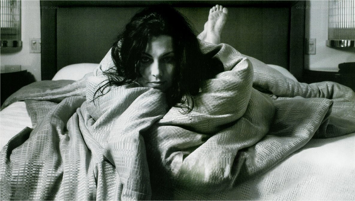 woman in bed under blanket
