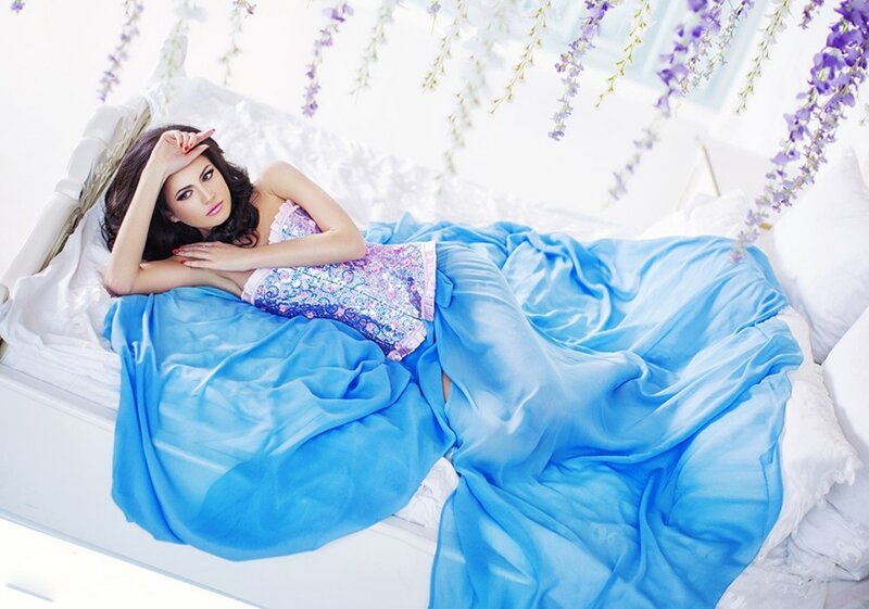 Woman in Bed with Blue Blanket — Serene