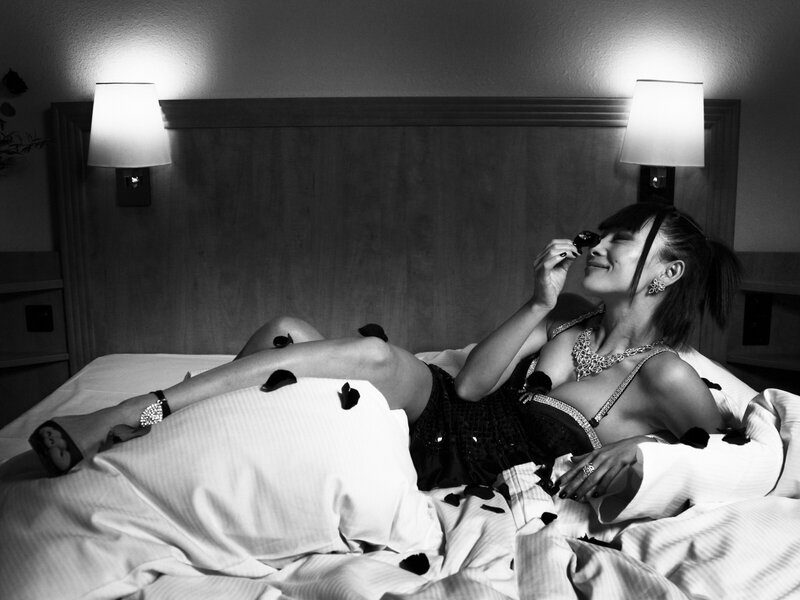 woman in bed with rose petals