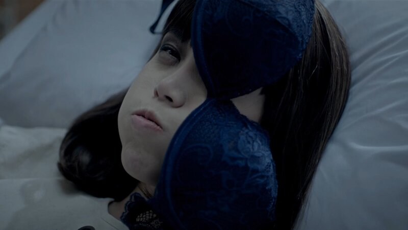 woman in bed with sleep mask