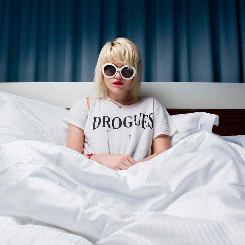 woman in bed with sunglasses