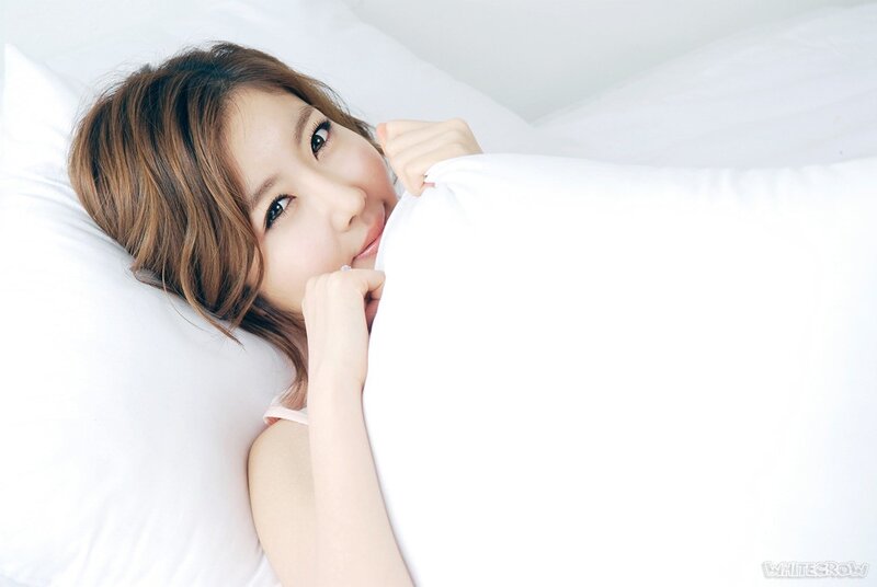 woman in bed with white pillow