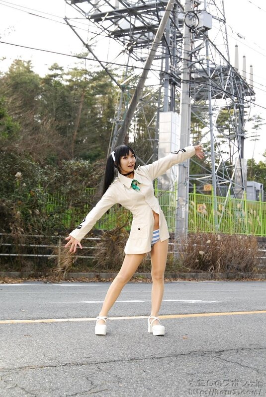 woman in beige coat posing on road