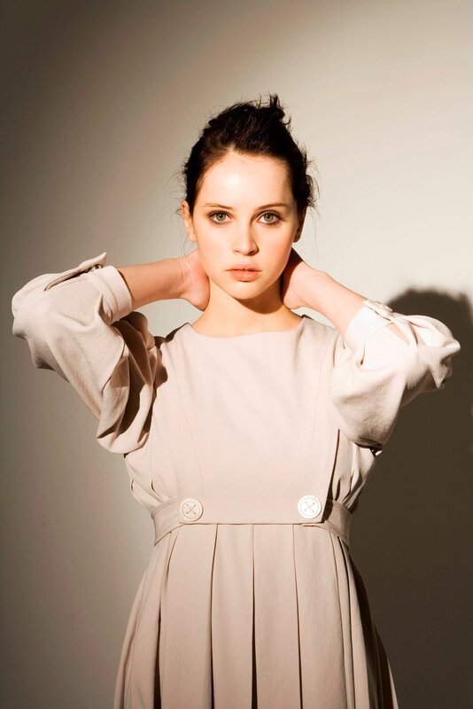 woman in beige dress posing