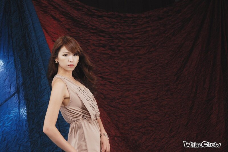 woman in beige dress posing