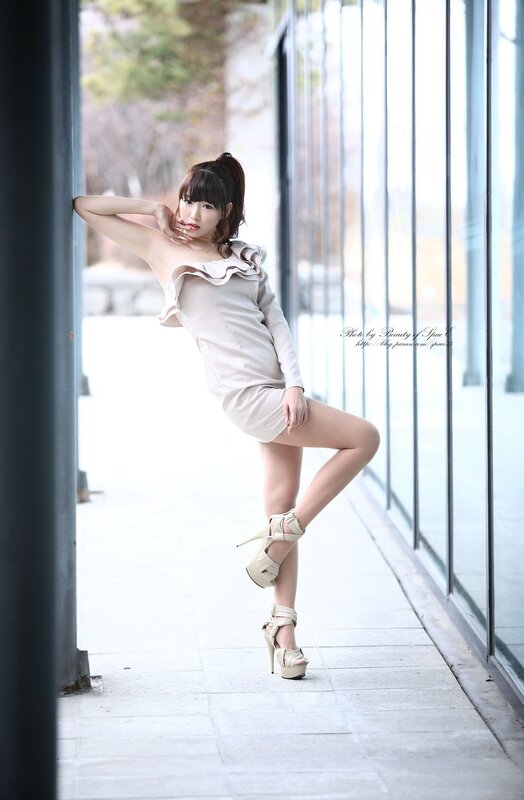 woman in beige dress posing