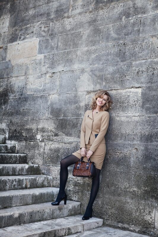 woman in beige suit on steps