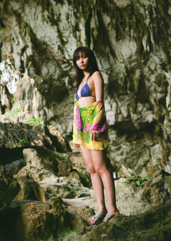 Woman in bikini at cave entrance