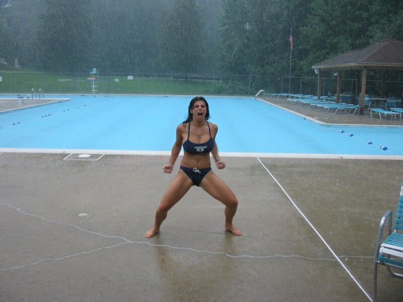 Woman in bikini at pool in rain