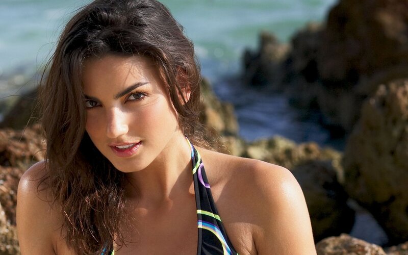 woman in bikini at rocky beach