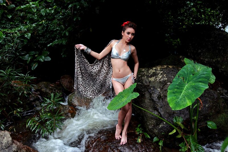 Woman in bikini by a stream