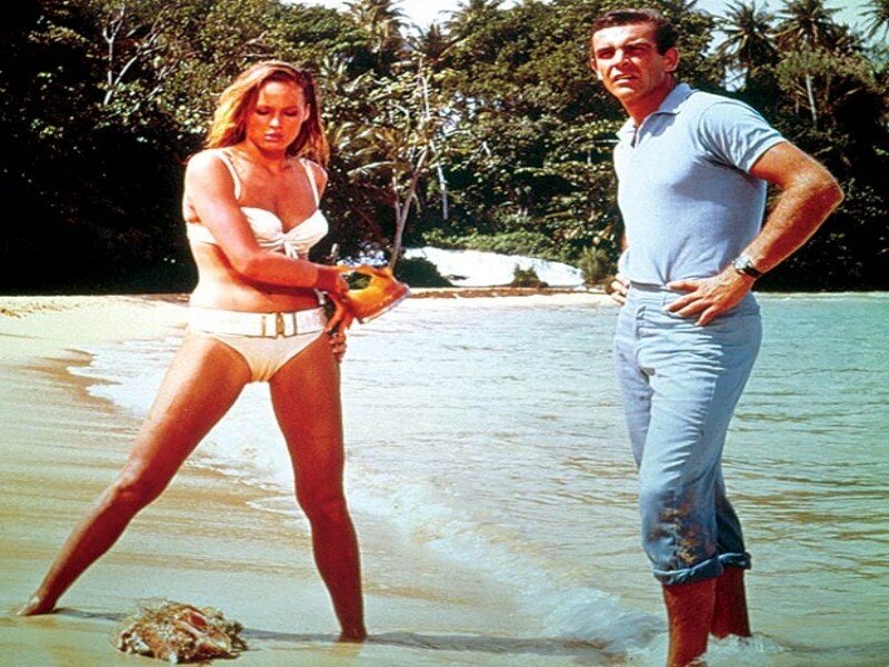 Woman in Bikini Holding Shell