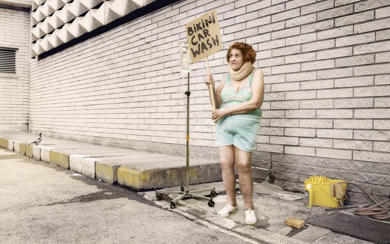 Woman in bikini holding sign
