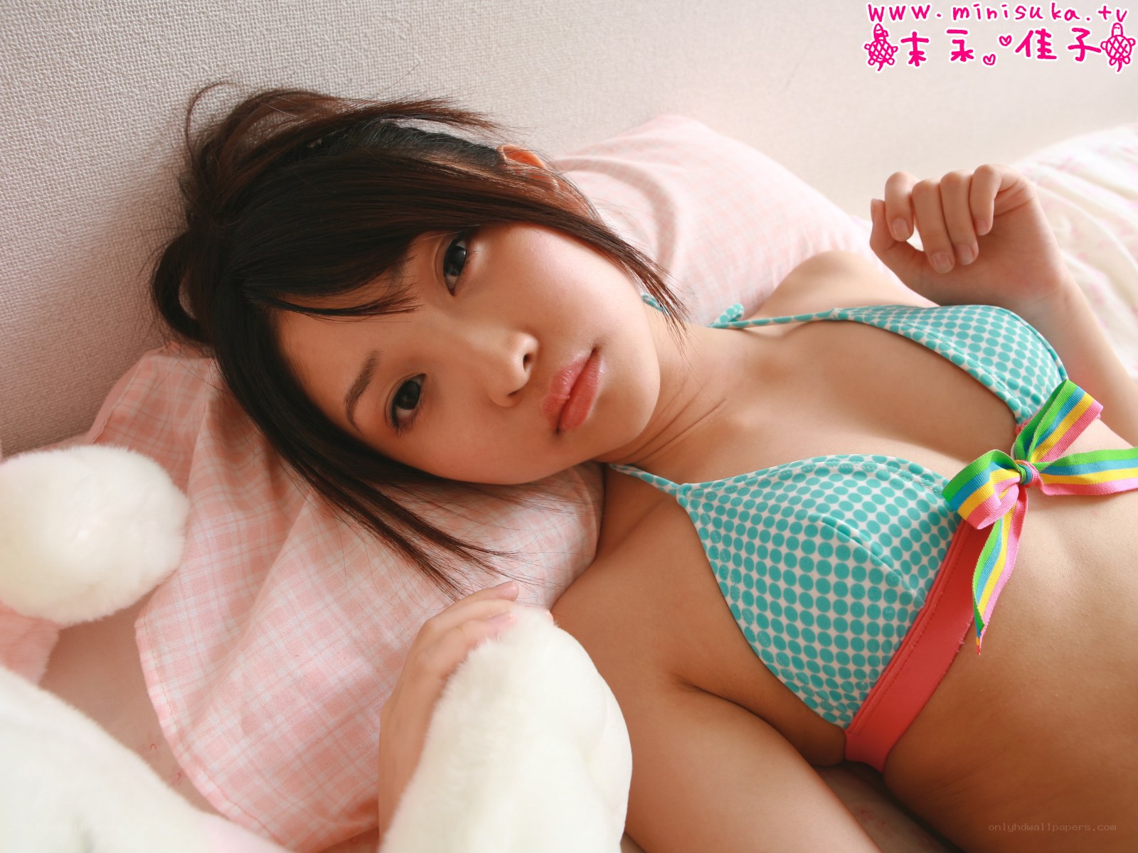 woman in bikini lying on bed