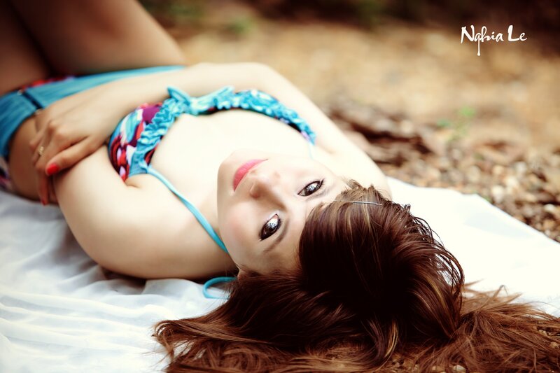 woman in bikini lying on blanket