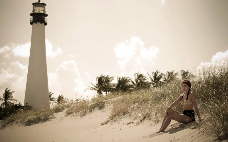 Woman in bikini near lighthouse