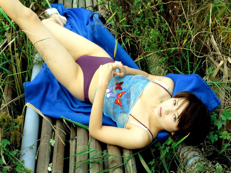 Woman in bikini on bamboo