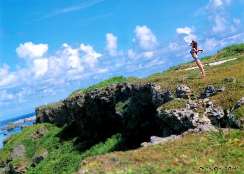 Woman in bikini on cliff