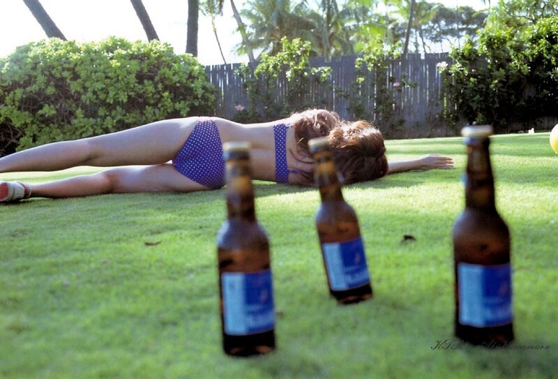 Woman in bikini on grass with bottles