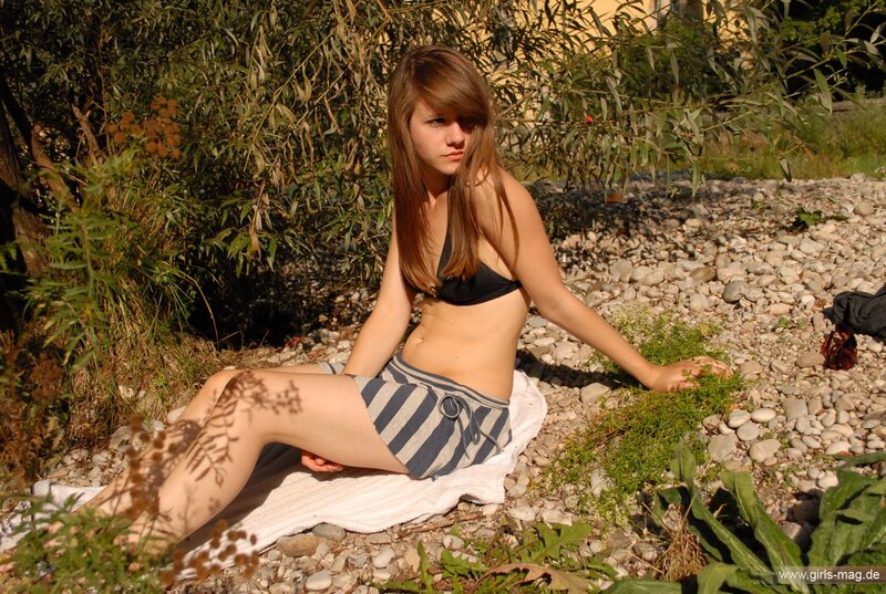 woman in bikini on pebbles
