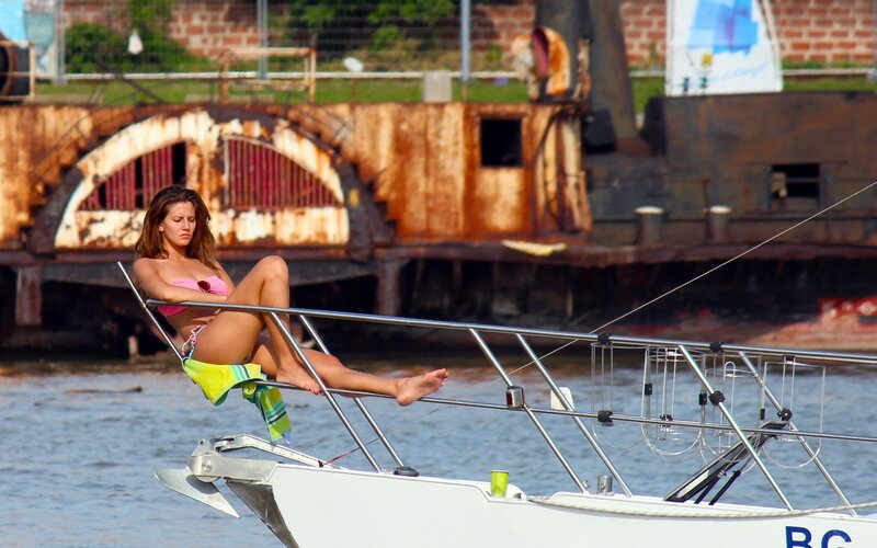 Woman in bikini on sailboat