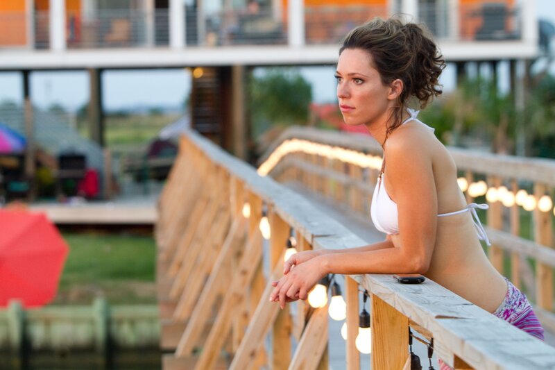 woman in bikini on wooden deck