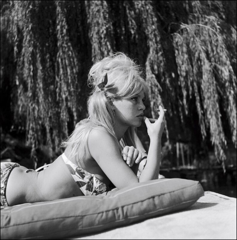 Woman in bikini smoking outdoors