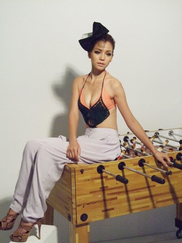 woman in bikini top on foosball table
