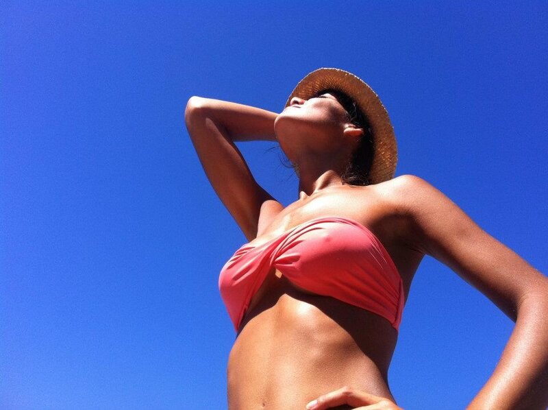 Woman in bikini under blue sky