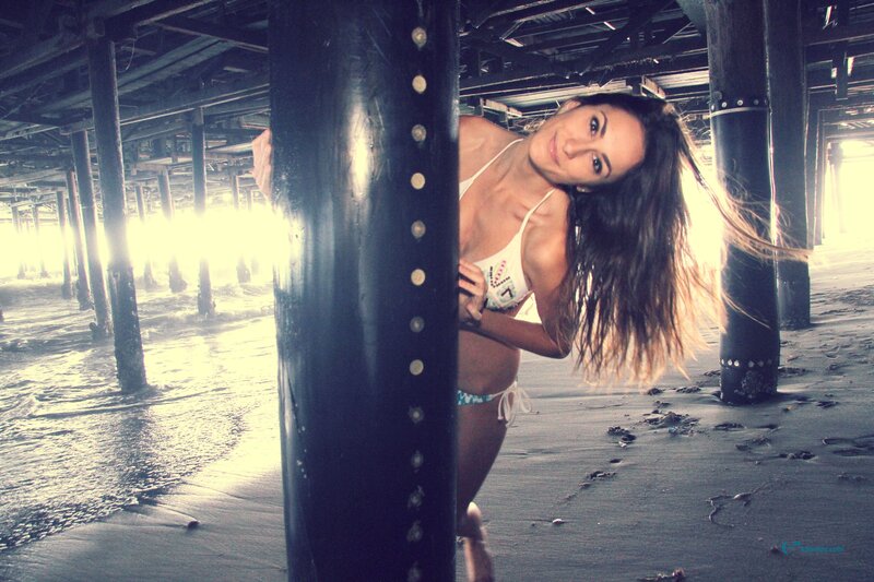 woman in bikini under pier
