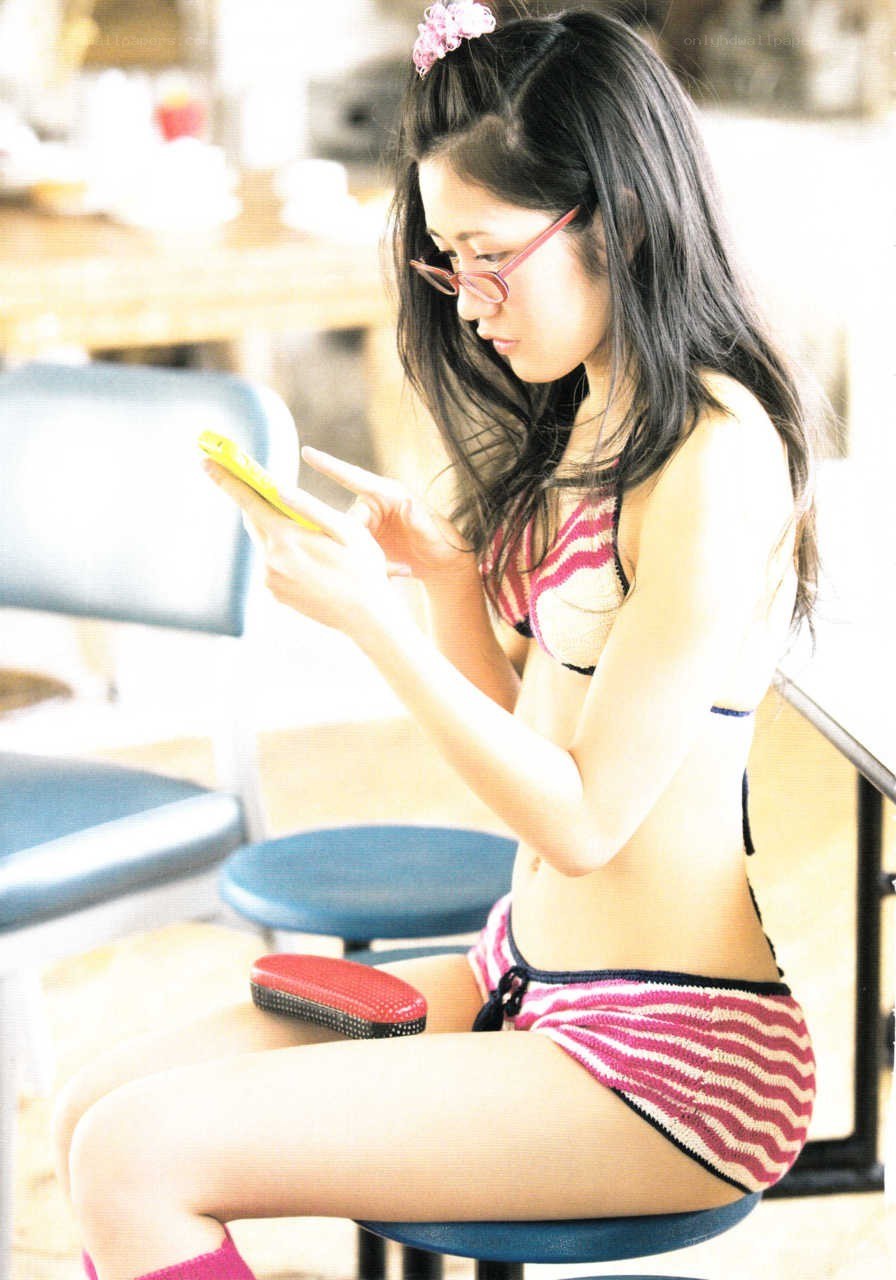 woman in bikini using phone