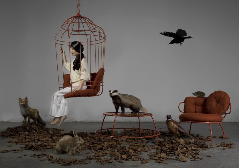 Woman in Birdcage Chair