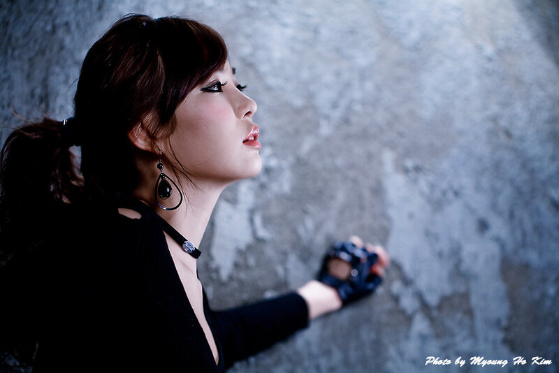 woman in black against concrete wall