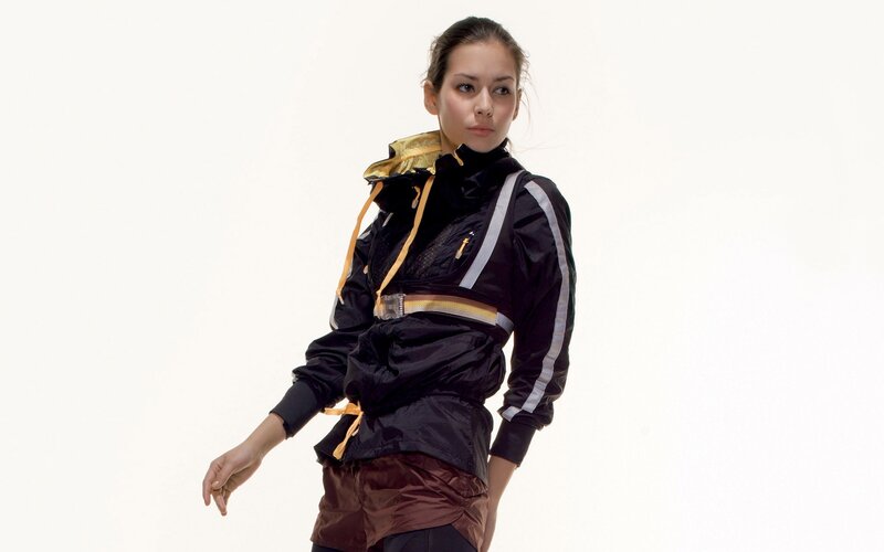 woman in black and gold jacket