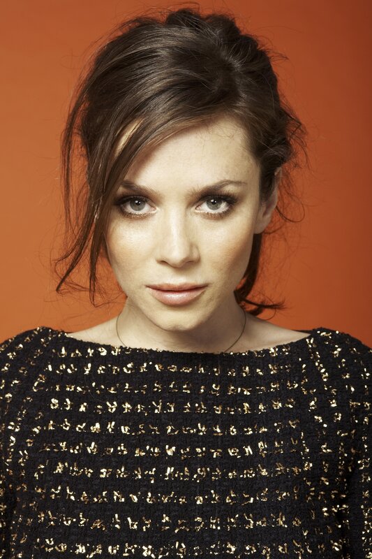 woman in black and gold top