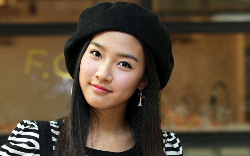 woman in black beret smiling