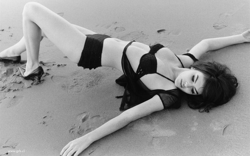 Woman in black bikini on beach