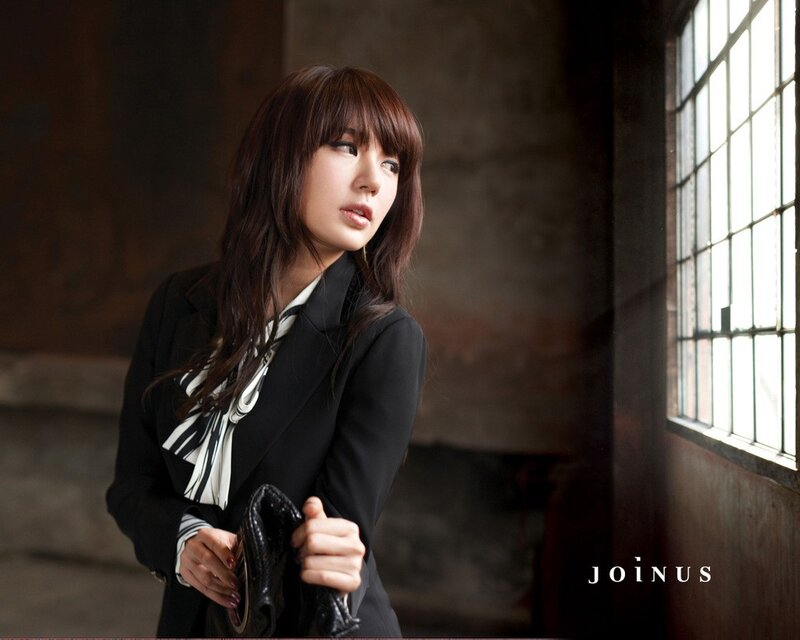 woman in black blazer by window