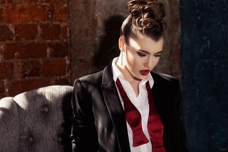 Woman in Black Blazer — Dramatic, Photograph, Brick Wall, Armchair